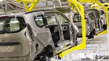 Vehicles on an assembly line in a factory.