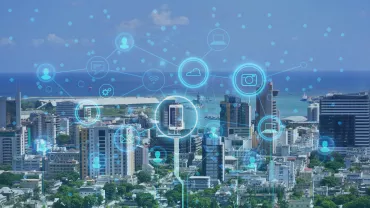 Cityscape with digital icons overlayed, representing connectivity.