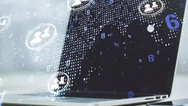 Laptop with digital graphics of network connections and people icons.