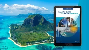 Aerial view of Mauritius coastline with a tablet displaying a salary guide.