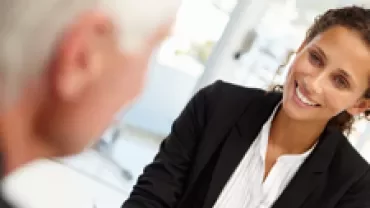 Two people having a conversation in an office.