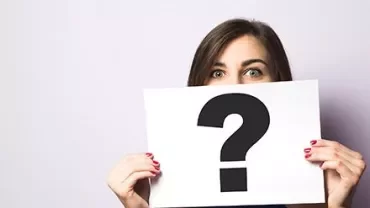 Person holding a sign with a question mark.