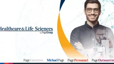 Smiling person with glasses and a lab technician in a healthcare setting.