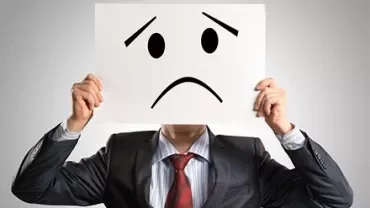 Person holding paper with sad face illustration