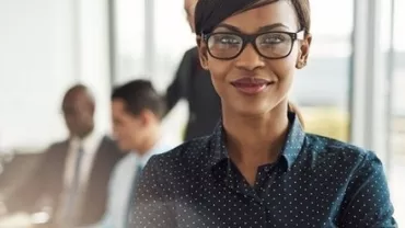 Person smiling in a modern office environment.