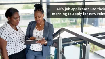 Two people reviewing a tablet, statistic about job applications shown.