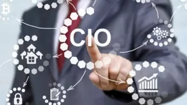 Person touching virtual screen with 'CIO' and technology icons.