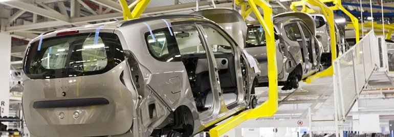 Cars in assembly line at factory.
