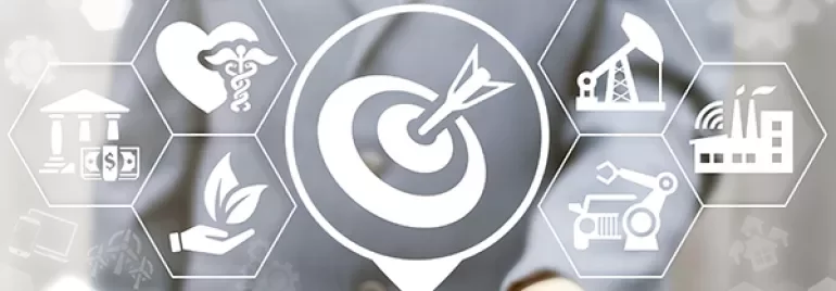 Business concept with target icon and various industries symbols on a digital display.
