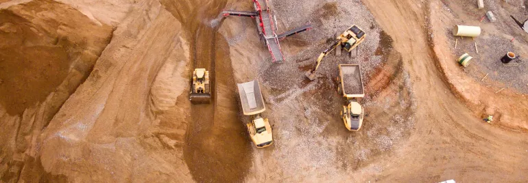 Aerial view of a busy construction site with multiple vehicles and equipment.