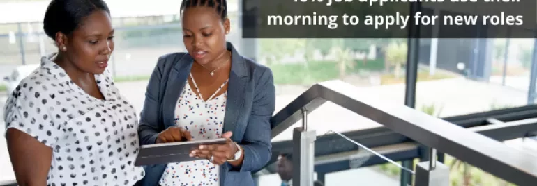 Two people reviewing a tablet, statistic about job applications shown.