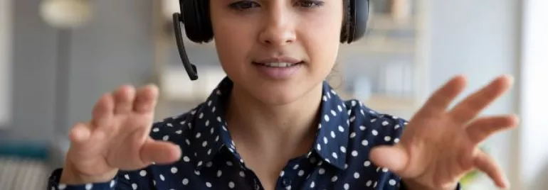 Individual wearing headphones, conducting a video call.
