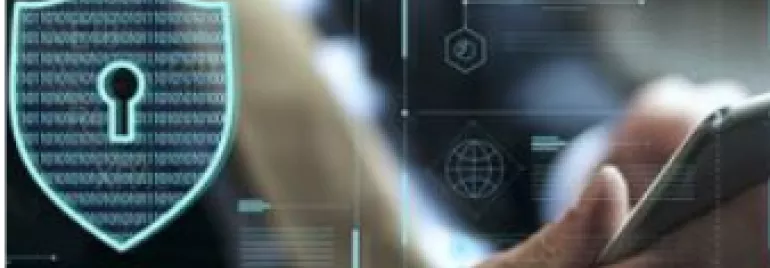 Person using a smartphone with digital security graphics on screen.