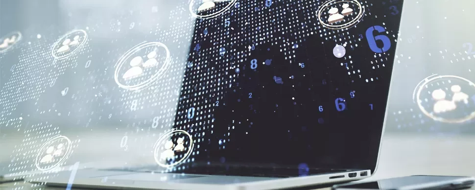 Laptop with digital graphics of network connections and people icons.