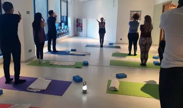 Yoga class with participants on mats following an instructor.