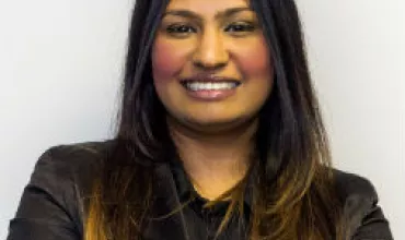 Person smiling, wearing a black shirt.