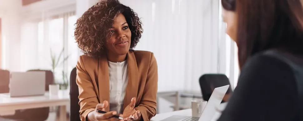 Two people having a discussion in an office.
