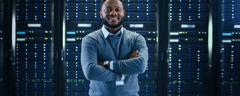 Person standing confidently in a server room.