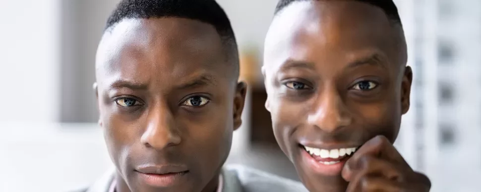 Close-up of one serious and one smiling person.