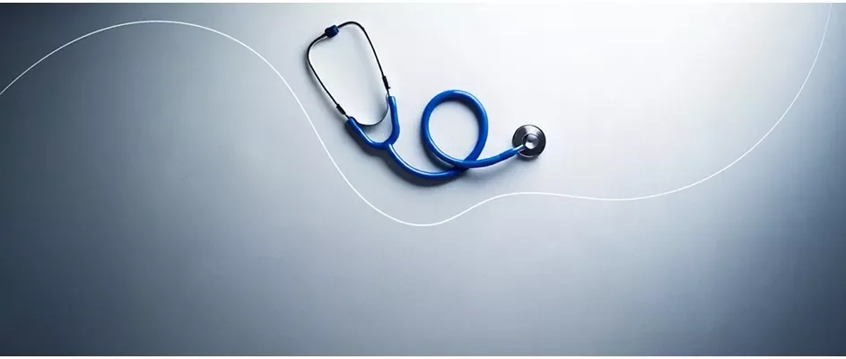 A blue sethoscope with a grey background.