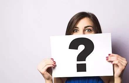 Person holding a sign with a question mark.